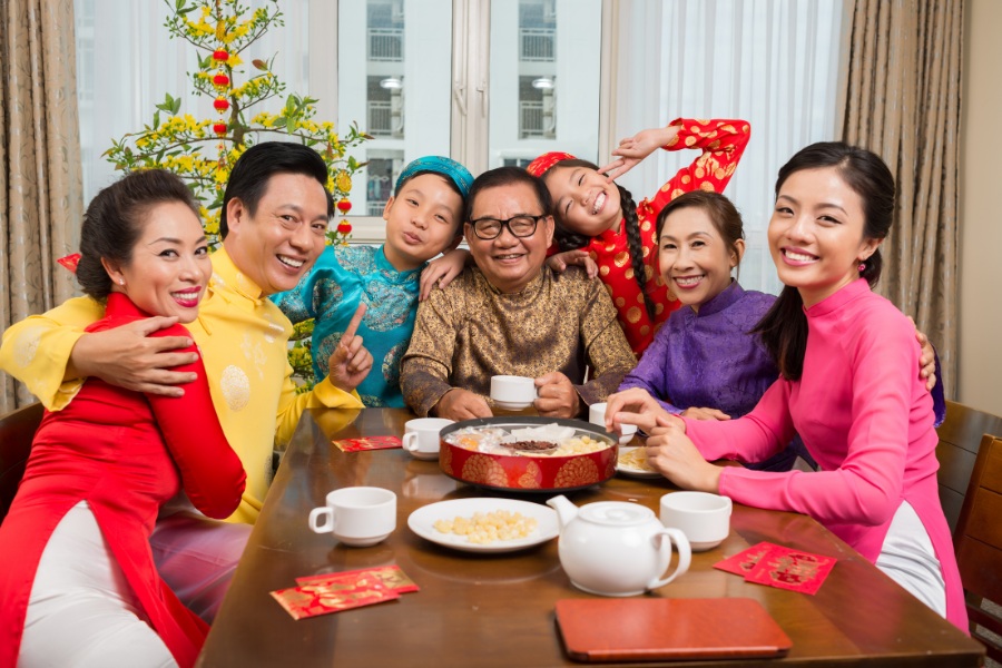 Traditional Tet gift box with red and gold tones, containing sticky rice cake and delicious candied fruits