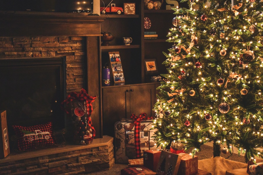 Warm Christmas gift box with sweet cakes, decorations and festive holiday spirit