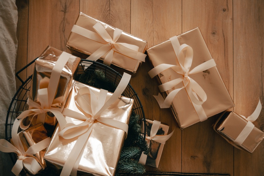 Gift recipient opening box with joyful expression and delighted surprise