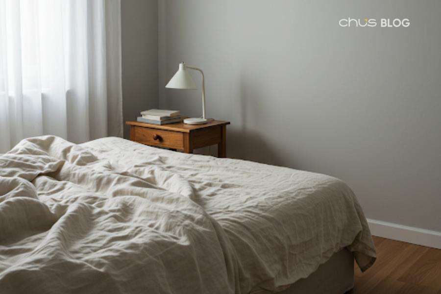 Minimalist bedroom space with light color tones - helps your brain relax and prepare for deep sleep