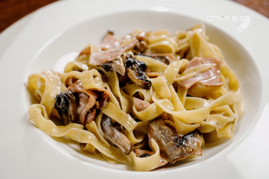Rich creamy mushroom pasta in a pristine white plate