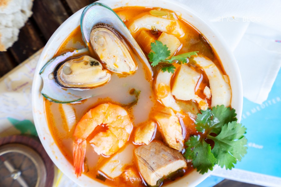 Hot seafood soup bowl with appealing golden glow