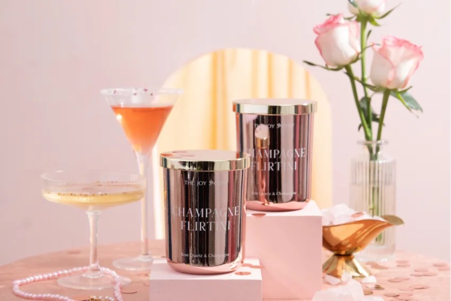 Sparkling pink scented candle lit up, creating warm and relaxing atmosphere