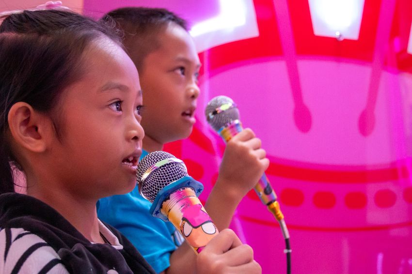Children confidently performing on stage during June 1st creates an absolutely adorable atmosphere